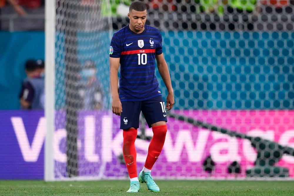 TOPSHOT - France's forward Kylian Mbappe reacts to their loss in the UEFA EURO 2020 round of 16 football match between France and Switzerland at the National Arena in Bucharest on June 28, 2021. – AFP