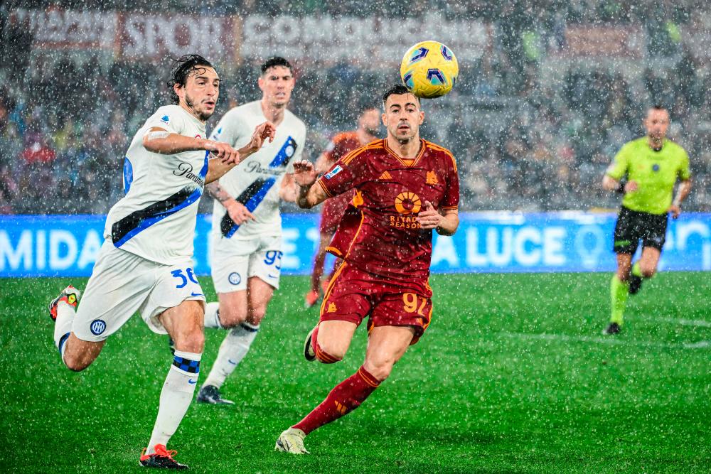 Inter Milan’s Italian defender #36 Matteo Darmian (L)L and Roma’s Italian forward #92 Stephan El Shaarawy go for the ball during the Italian Serie A football match between AS Roma and Inter Milan at the Olympic stadium in Rome on February 10, 2024/AFPPix