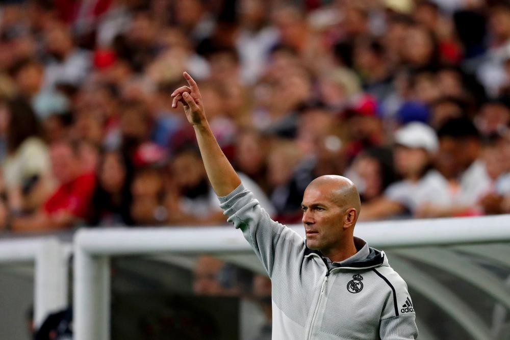 Real Madrid head coach Zinedine Zidane coaches against Bayern Munich during their International Champions Cup match on July 20, 2019 at NRG Stadium in Houston, Texas. — AFP