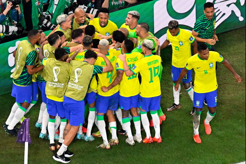 Brazil’s players celebrate scoring their first goal during the Qatar 2022 World Cup Group G football match between Brazil and Switzerland at Stadium 974 in Doha on November 28, 2022. AFPPIX