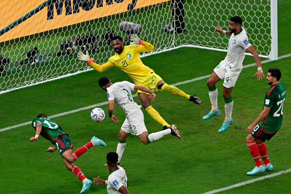 TOPSHOT - Mexico's midfielder #17 Orbelin Pineda fails to score past Saudi Arabia's goalkeeper #21 Mohammed Al-Owais during the Qatar 2022 World Cup Group C football match between Saudi Arabia and Mexico at the Lusail Stadium in Lusail, north of Doha on November 30, 2022. AFPPPIX