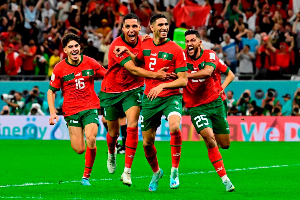 Filepix: Morocco’s defender #02 Achraf Hakimi (C) celebrates with teammates after converting the last penalty during the penalty shoot-out to win the Qatar 2022 World Cup round of 16 football match between Morocco and Spain at the Education City Stadium in Al-Rayyan, west of Doha on December 6, 2022. AFPPIX