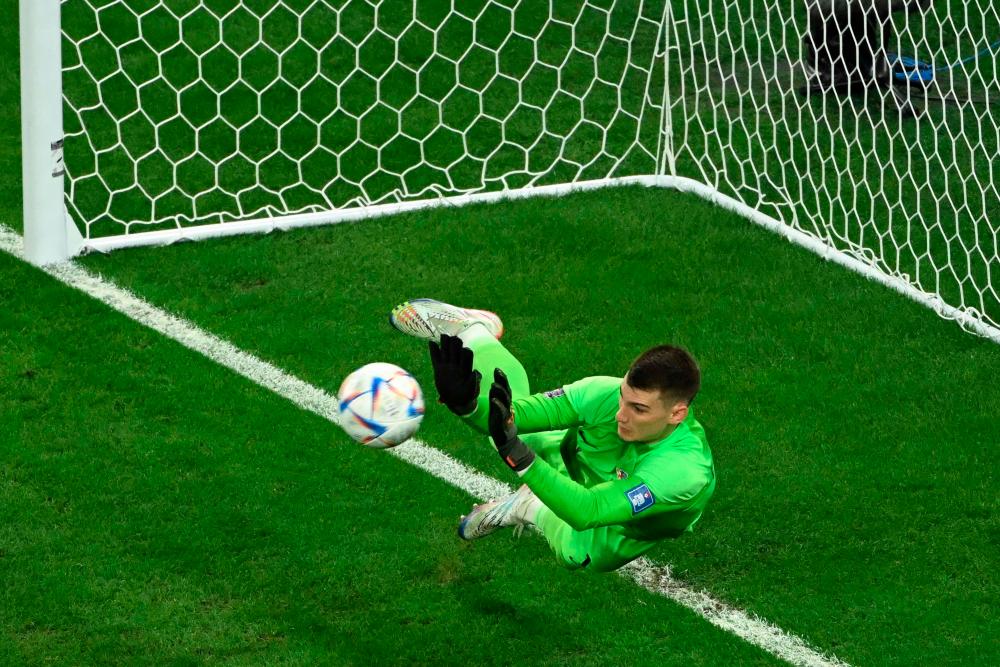 Croatia’s goalkeeper #01 Dominik Livakovic saves a goal by Brazil’s forward #21 Rodrygo during a penalty shoot-out in the Qatar 2022 World Cup quarter-final football match between Croatia and Brazil at Education City Stadium in Al-Rayyan, west of Doha, on December 9, 2022/AFPPix