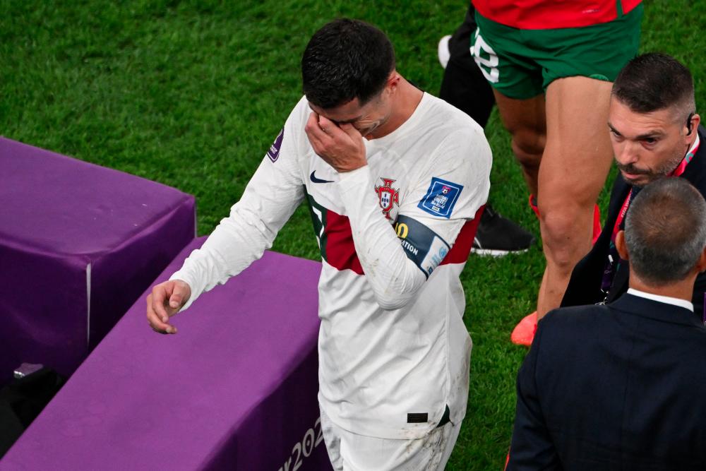 TOPSHOT - Portugal's forward #07 Cristiano Ronaldo leaves the field after losing to Morocco 1-0 in the Qatar 2022 World Cup quarter-final football match between Morocco and Portugal at the Al-Thumama Stadium in Doha on December 10, 2022. - AFPPIX