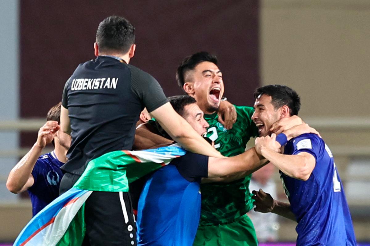 Uzbekistan’s players celebrate after their 2026 FIFA World Cup Asian Qualifier football match against the United Arab Emirates ended in a draw, qualifying them for the World Cup for the first time, at Al-Nahyan Stadium in Abu Dhabi on June 5, 2025. AFP