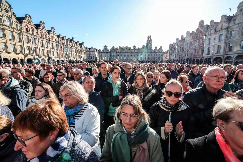 People gather to pay tribute at Heroes square in Arras, northeastern France on October 15, 2023, two days after a teacher was killed and two other people were severely wounded on October 13, in a knife attack at the Gambetta high school. AFPPIX