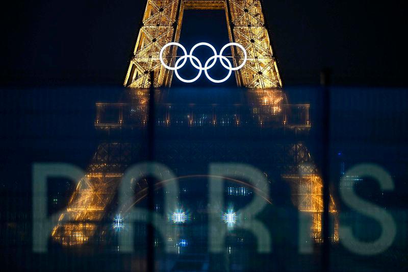 This photograph shows the Eiffel Tower bearing the Olympics rings, lit-up ahead of the Paris 2024 Olympic and Paralympic games - AFPpix