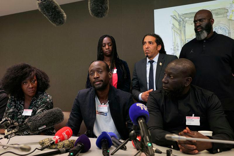 Older brother of slain young Malian man Aboubakar Cisse, Yoro Cisse (C) speaks during a meeting and press conference to address the killing of his brother, at the National Assembly in Paris - AFPpix