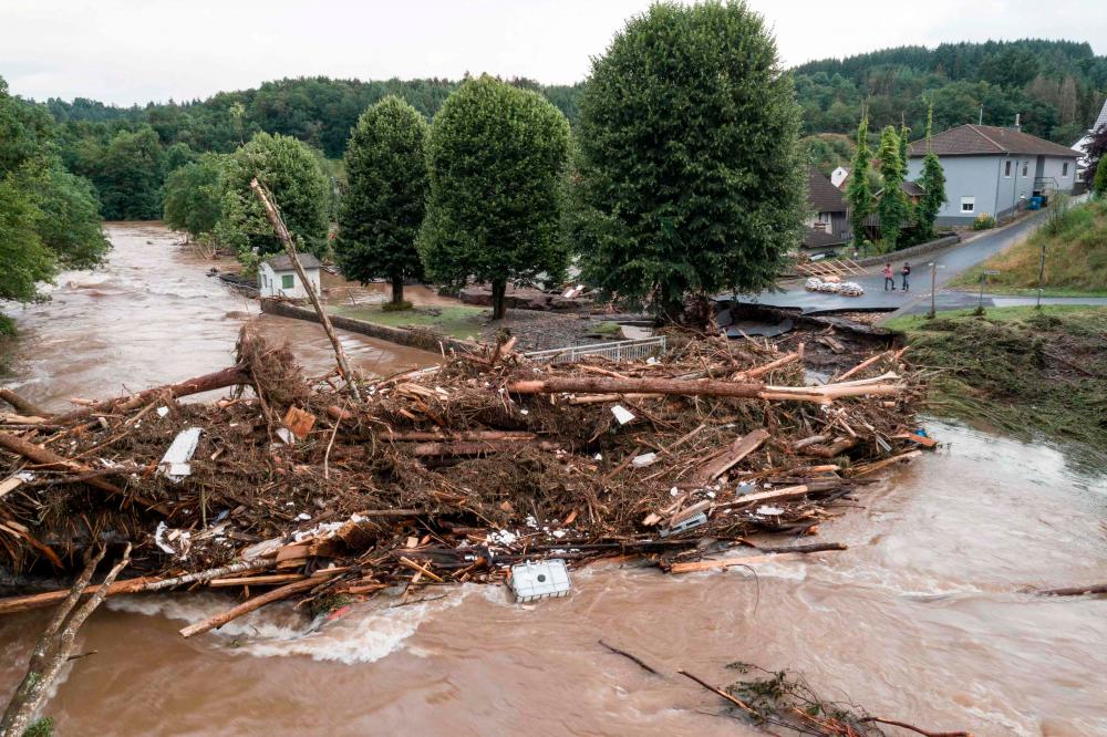 A photo taken on July 15, 2021 shows a bridge damaged by trunks and debris following heavy rains and flood in Echtershausen, near Bitburg, western Germany. – AFP