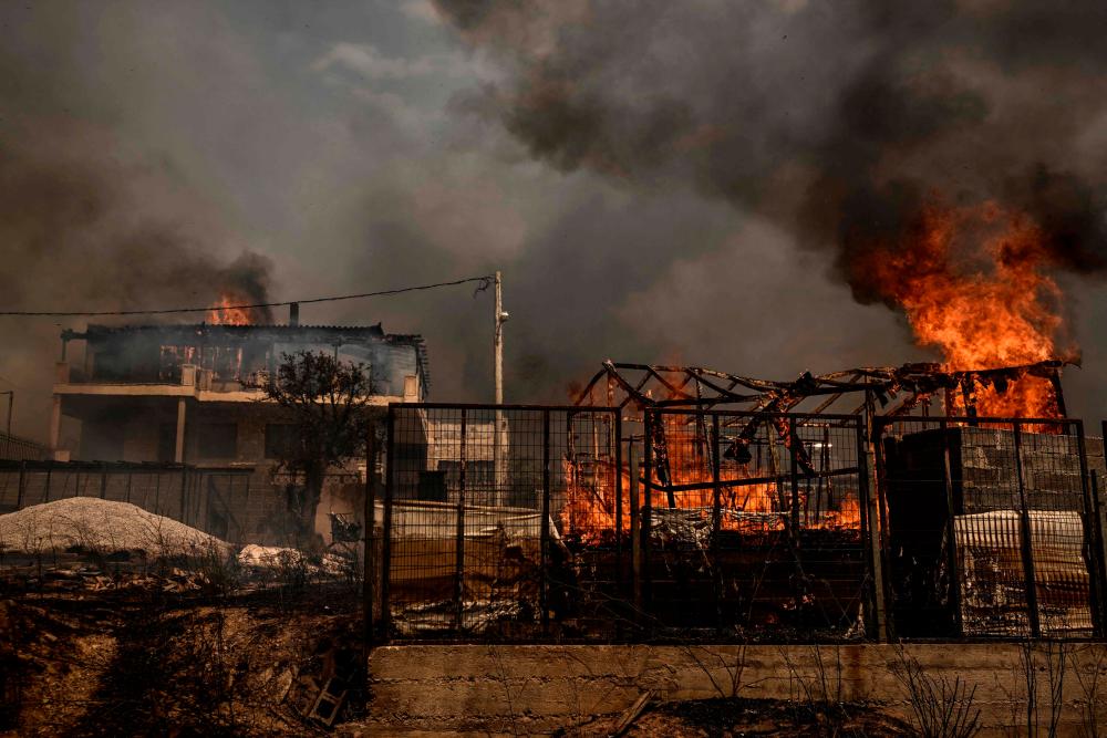 This photograph taken on August 23, 2023 shows a burnt house as a wildfire spreads in Archanes, north of Athens/AFPPix