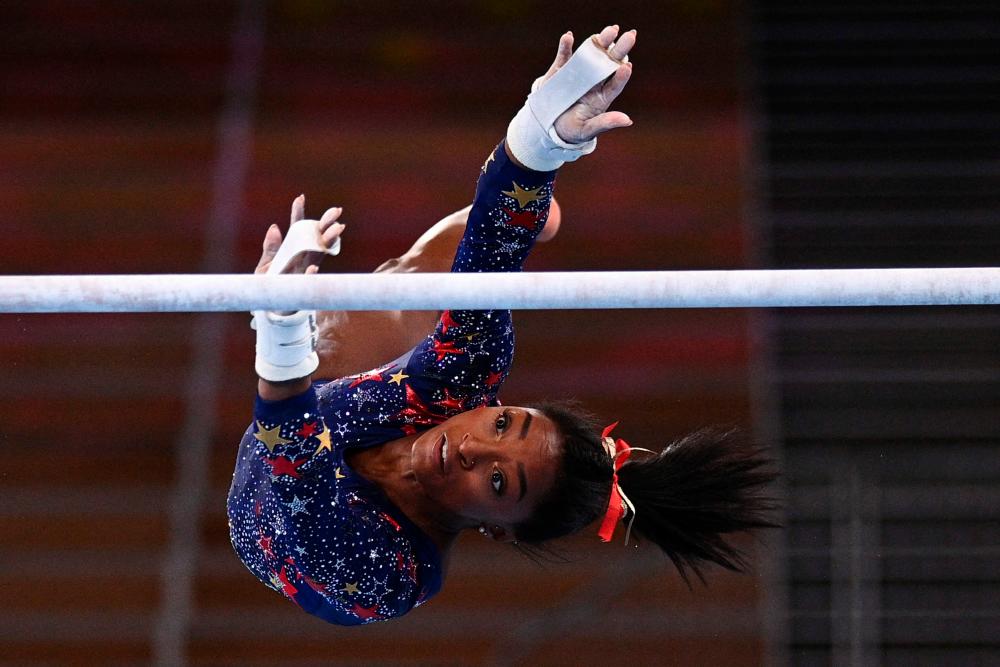 USA’s Simone Biles competes in the uneven bars event of the artistic gymnastics women’s qualification during the Tokyo 2020 Olympic Games at the Ariake Gymnastics Centre in Tokyo on July 25, 2021. -AFP