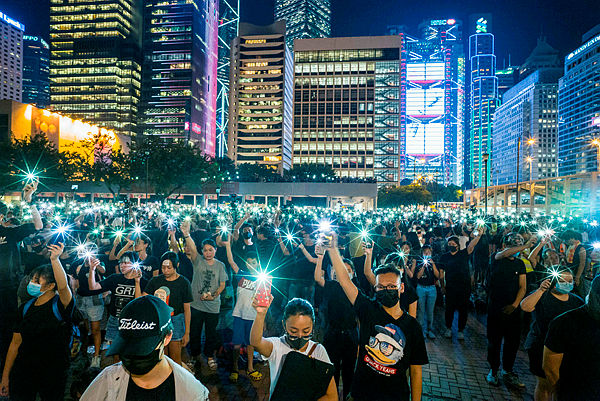 Secondary school students raise their phone torches as they sing ‘Do You Hear the People Sing’ from ‘Les Miserables’ while attending a rally at Edinburgh Place in Hong Kong on Aug 22. — AFP