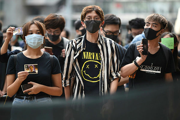 Masked protesters gather outside the High Court premises in support of activist Edward Leung, jailed for taking part in the 2016 Mongkok riots, during an appeal hearing for his period of sentence in Hong Kong on October 9, 2019. — AFP