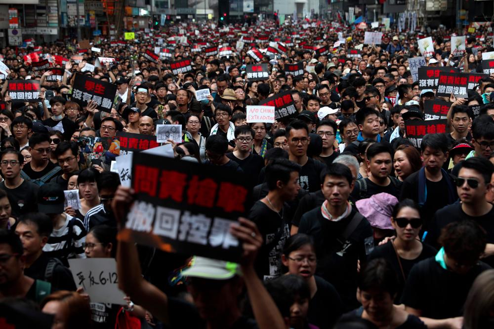 Thousands of protesters dressed in black take part in a new rally against a controversial extradition law proposal in Hong Kong on June 16, 2019. — AFP