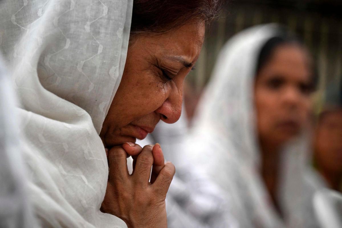 A relative mourns during a special prayer organised for the victims killed in the Air India flight crash before the funeral ceremony in Ahmedabad on June 15, 2025.
