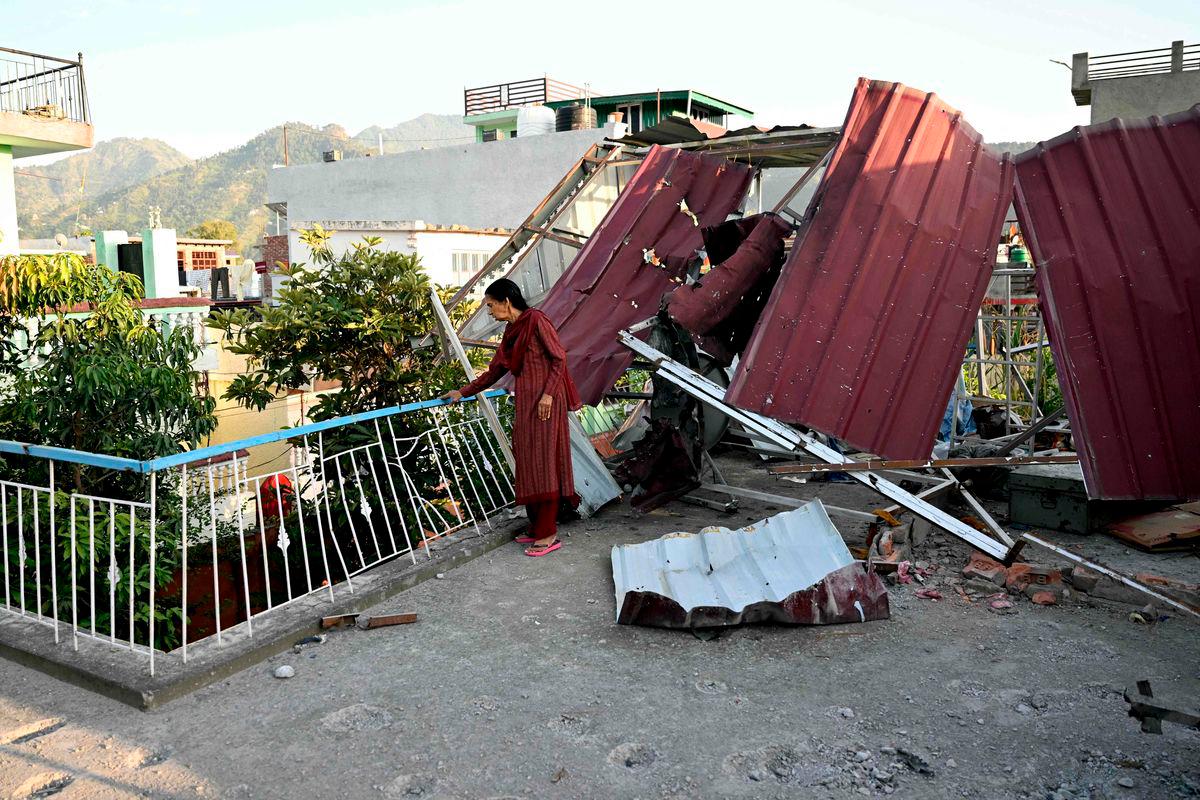 A woman stands at her damaged home after Pakistan launched missiles in Kashmir’s Poonch, on May 14, 2025. Tens of thousands of people living near the border of Indian-administered Kashmir fled as the nuclear-armed rivals fought a four-day conflict from May 7. AFPpix