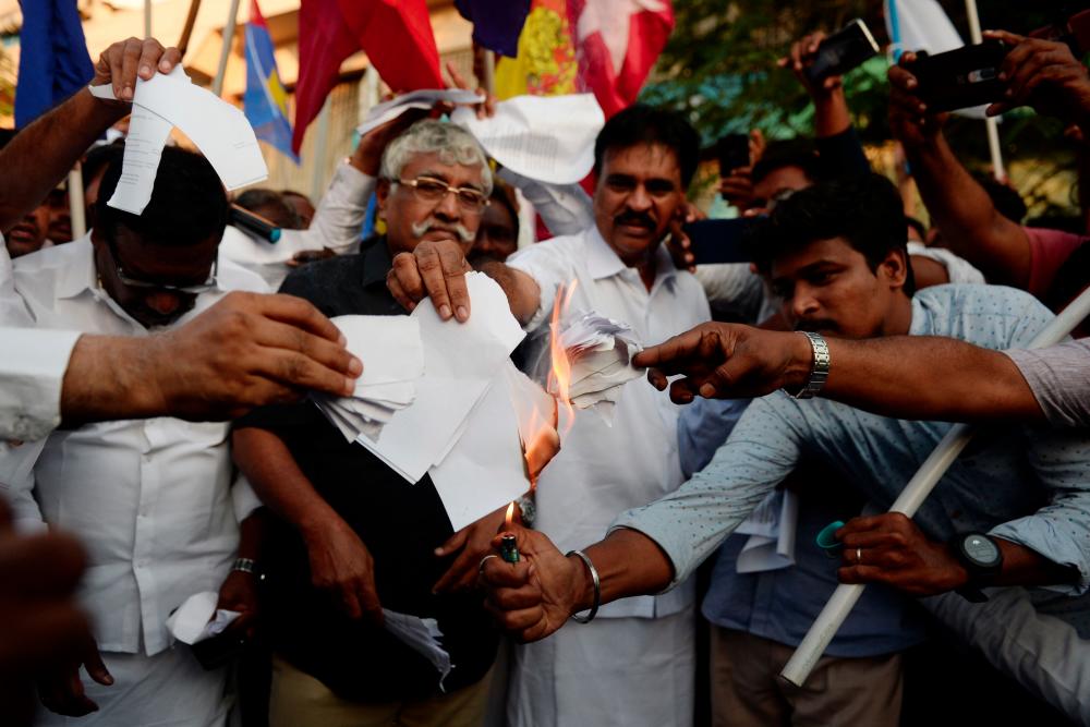 Demonstrators burns a copy of the Citizenship Amendment Bill (CAB) during a demonstration in Chennai on Dec 12. — AFP