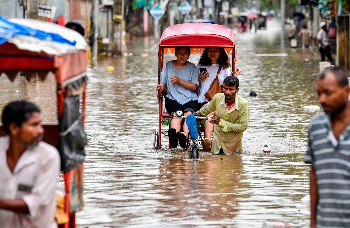 Women commute in cycle rickshaws through a flooded street after heavy rains in Guwahati, in India’s Assam state on May 31, 2025. AFPpix