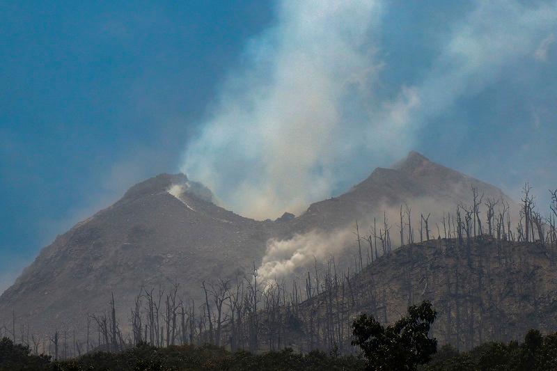 Smoke billows from Mount Lewotobi Laki-Laki as seen from Klatanlo village, in East Flores Regency, East Nusa Tenggara, on November 4, 2024, after it erupted overnight. At least six people died after a volcano in eastern Indonesia erupted several times overnight, officials said on November 4, raising the alert level to the highest of a four-tiered system. - ARNOLD WELIANTO / AFPpix