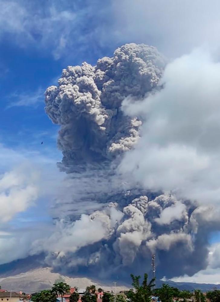 This handout photo taken and released on August 10, 2020 from Indonesia’s Centre for Investigation and Technology Development of Geological Disaster (BPPTKG) shows Mount Sinabung as it spews thick ash and smoke into the sky in Karo, North Sumatra. — AFP