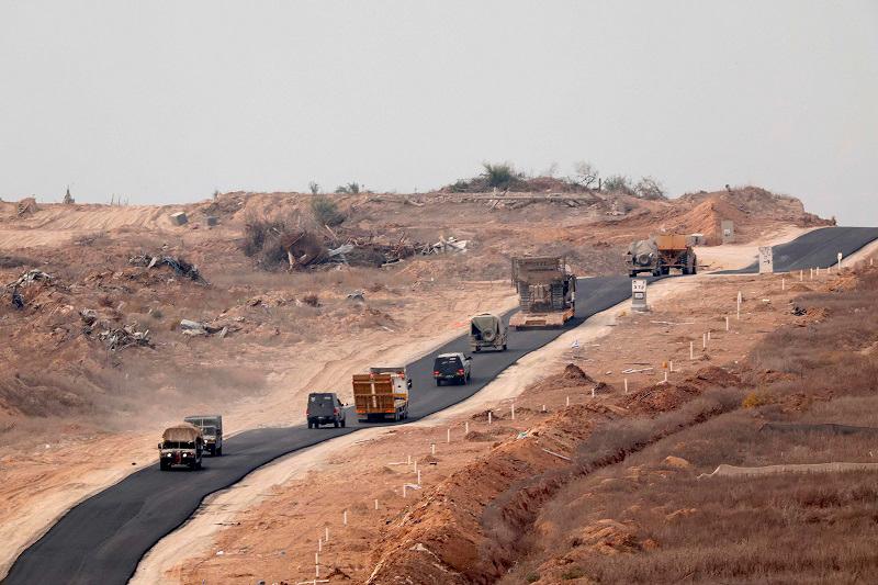 A picture taken from Israel’s southern border with the Gaza Strip on December 11, 2024, shows Israeli army vehicles driving down a road inside the Palestinian territory, amid the ongoing war between Israel and the militant group Hamas. - JACK GUEZ / AFP