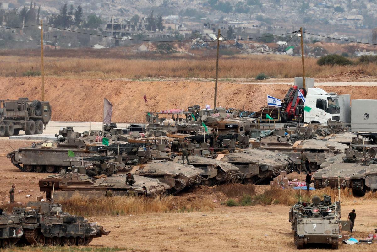 Israeli troops deploy on Israel’s border with the Gaza Strip (background). AFPpix