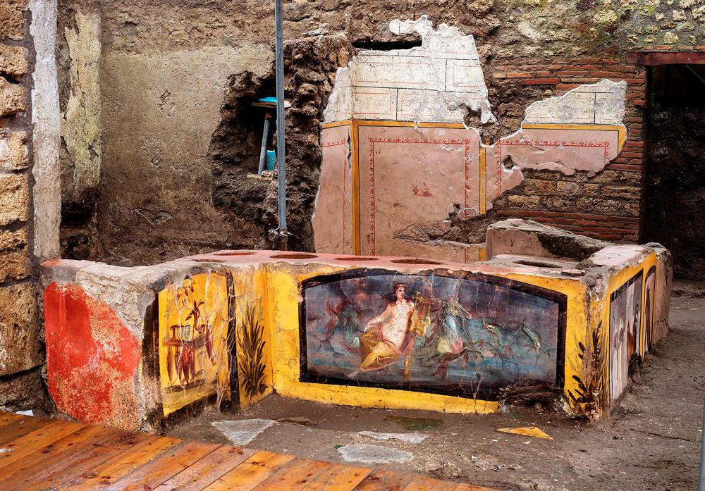 TOPSHOT - This picture released on December 26, 2020 by the Pompei Press Office shows a thermopolium, a sort of street “fast-food” counter in ancient Rome, that has been unearthed in Pompei, decorated with polychrome motifs and in an exceptional state of preservation. AFP PHOTO / POMPEI PRESS OFFICE