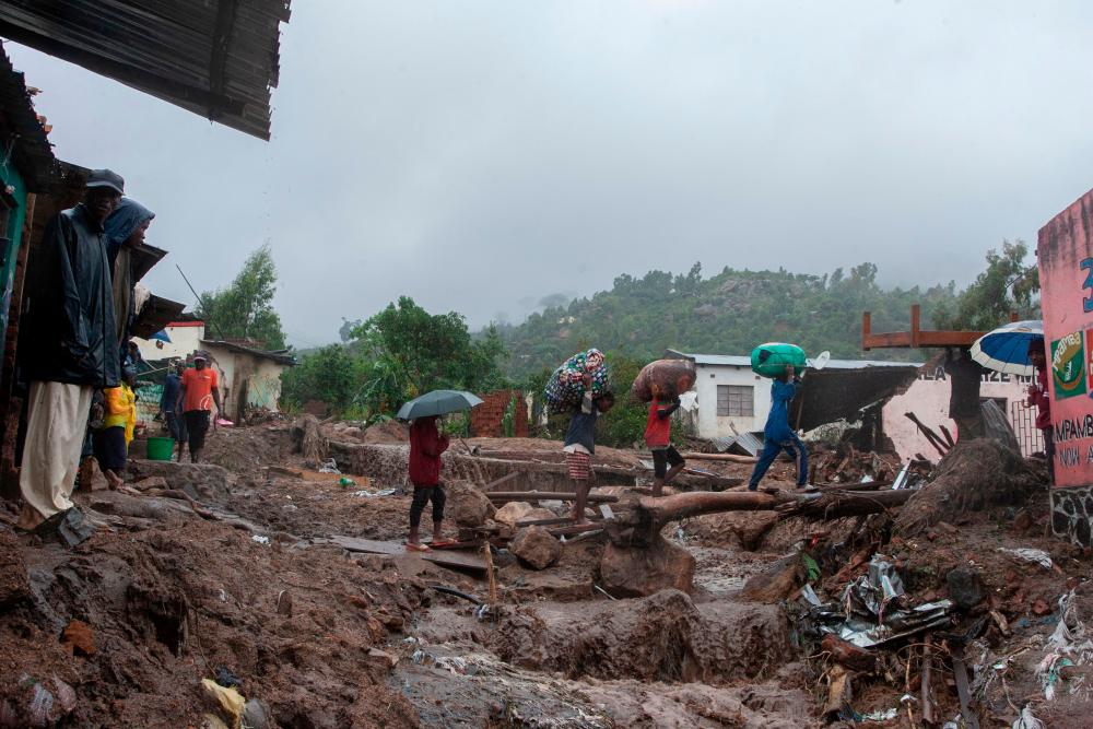 People repatriate residents and their property from a flood affected Chimwankhunda location in Blantyre on March 14, 2023 following heavy rains caused by cyclone Freddy. AFPPIX