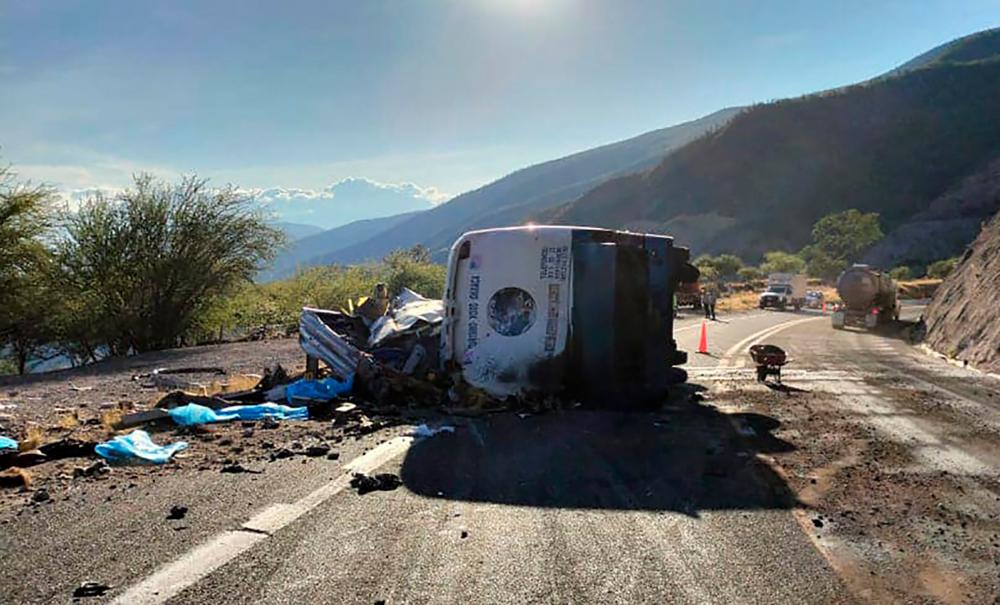 Handout picture released by Mexico’s Civil Protection taken at the site of a bus accident in which at least 18 migrants were killed, in Cuacnopalan, Oaxaca State, Mexico, on October 6, 2023/AFPPix