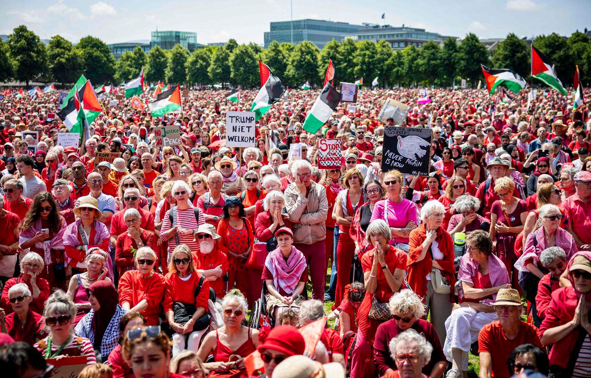 Protestors wave Palestinian flags and signs as they attend a demonstration called by Oxfam Novib, PAX, Amnesty International, Save the Children and Doctors Without Borders in support for the Palestinians, in The Hague on June 15, 2025. (Photo by ANP KOEN VAN WEEL / ANP / AFP)