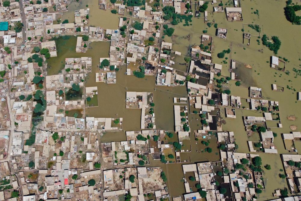 TOPSHOT - This aerial photograph taken on August 31, 2022 shows flooded residential areas after heavy monsoon rains in Jaffarabad district of Balochistan province. - AFPPIX
