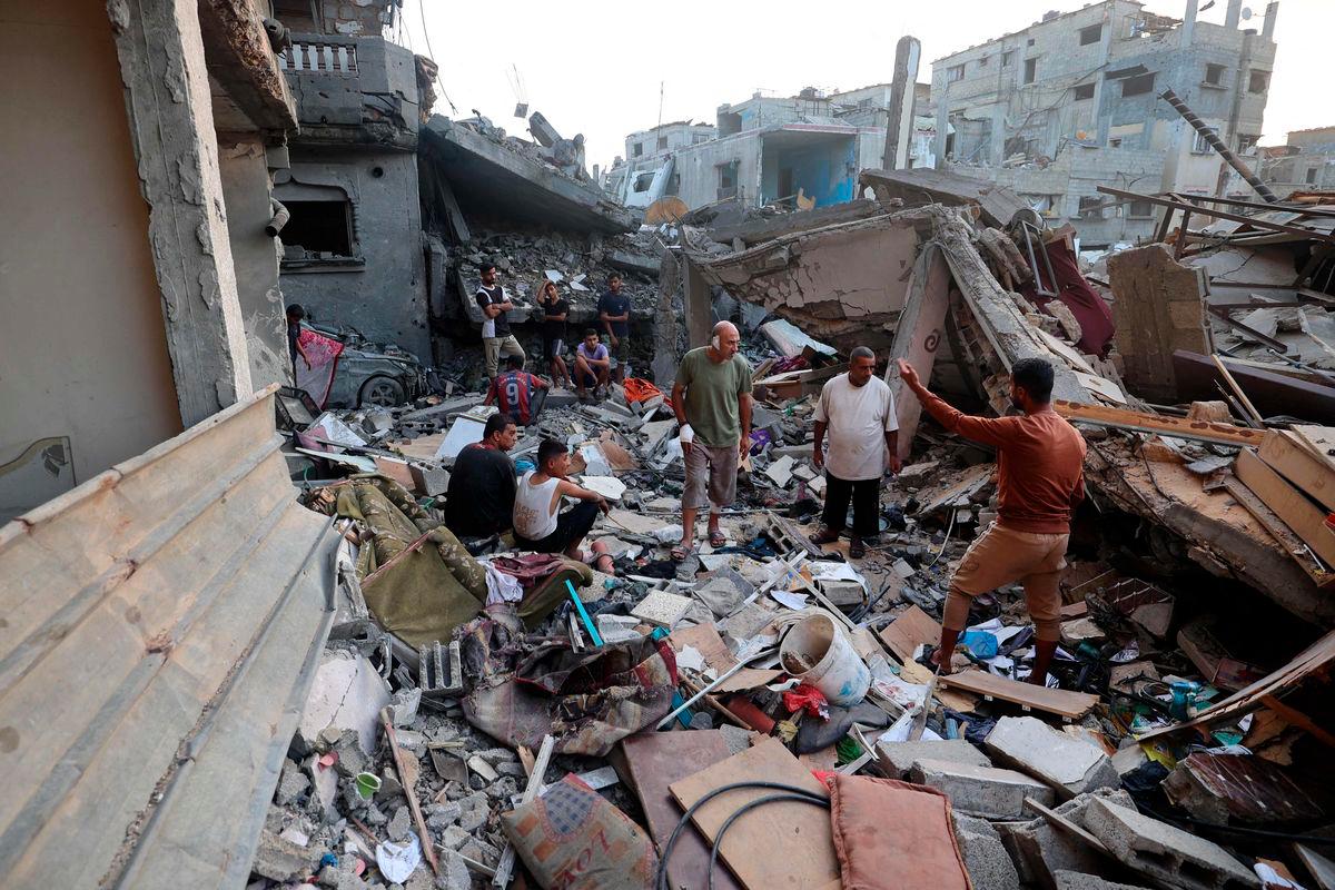 Palestinians check the rubble of a building destroyed by an Israeli strike in the Nuseirat refugee camp in the central Gaza Strip on September 28, 2025. (Photo by Eyad BABA / AFP)