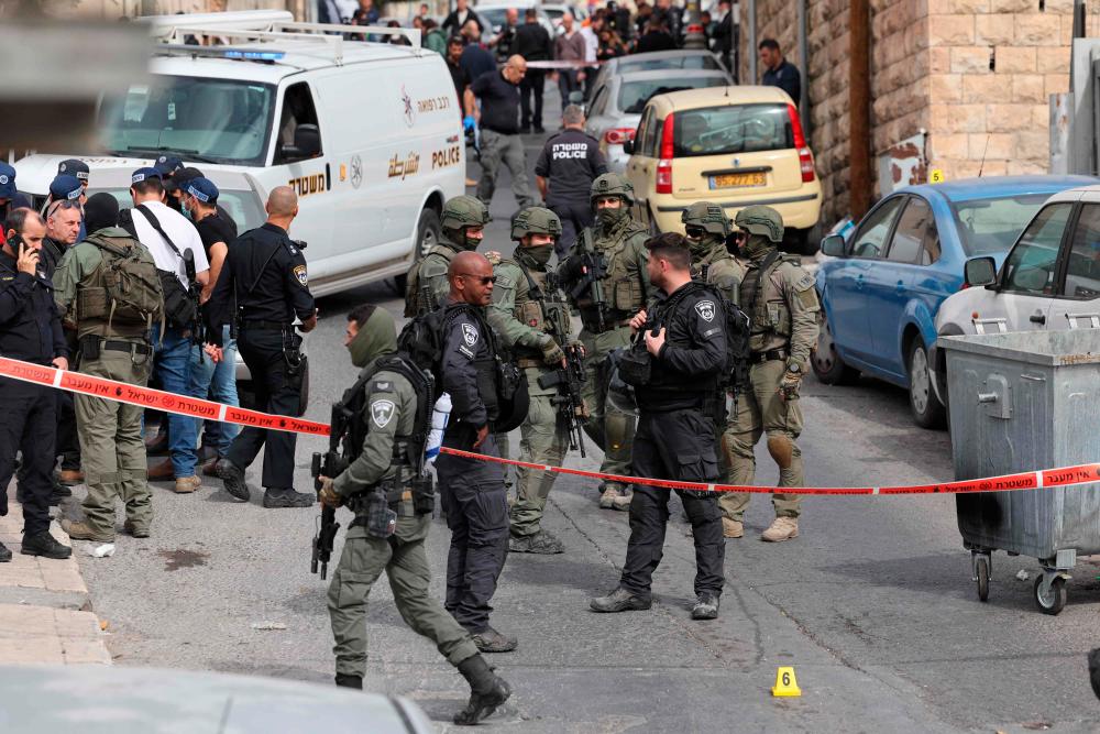 Israeli security forces and emergency service personnel gather at a cordoned-off area in Jerusalem’s predominantly Arab neighbourhood of Silwan, where an assailant reportedly shot and wounded two people, on January 28, 2023. AFPPIX