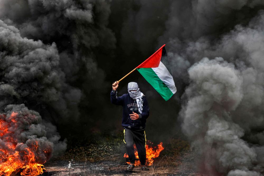 Palestinian youths burn tires during a protest near the Israel-Gaza border east of Jabalia refugee camp, on February 23, 2023. AFPPIX