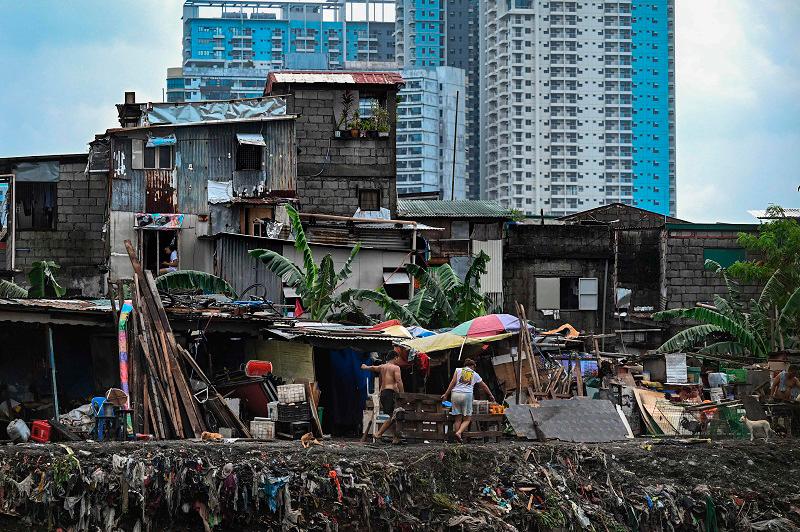Residents clean their houses in the aftermath of Typhoon Gaemi in Manila on July 25, 2024. - AFPpix