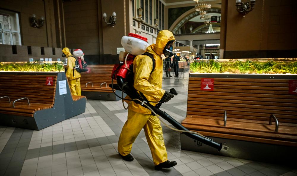 A serviceman of Russia’s Emergencies Ministry, wearing protective gear, disinfects Kievsky railway terminal amid the COVID-19 pandemic in Moscow on September 2021. AFPPIX