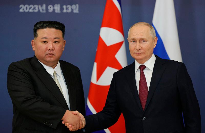 This pool image distributed by Sputnik agency shows Russian President Vladimir Putin (R) and North Korea’s leader Kim Jong Un (L) shaking hands during their meeting at the Vostochny Cosmodrome in Amur region on September 13, 2023, ahead of planned talks that could lead to a weapons deal with Russian President. (Photo by Vladimir SMIRNOV / POOL / AFP)