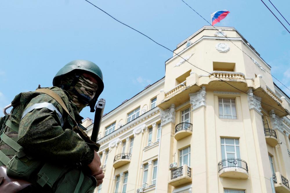 A member of Wagner group stands guard in a street in the city of Rostov-on-Don, on June 24, 2023. AFPPIX
