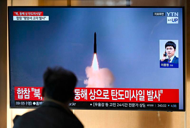 A man watches a television screen showing a news broadcast with file footage of a North Korean missile test, at a train station in Seoul - AFPpix