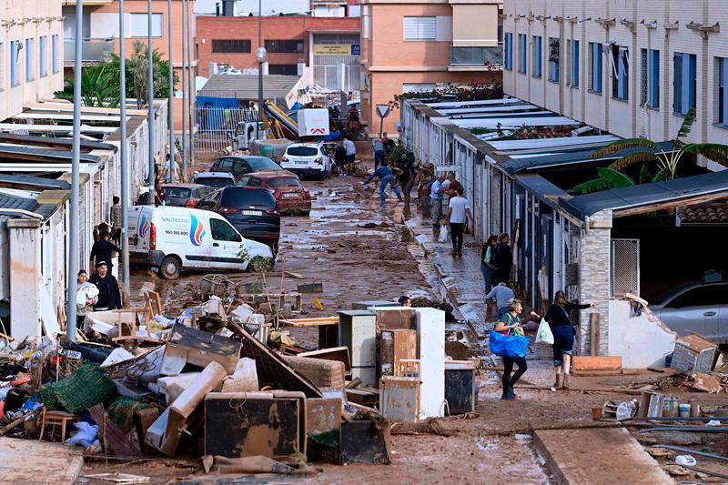 This picture taken on November 1, 2024 shows the devastating effects of flooding on a residential area in the town of Alfafar, in the region of Valencia, eastern Spain. Spanish defense minister announced today the arrival of an additional 500 soldiers in southeastern Spain, reinforcing the 1,200 already present, to assist in relief operations for the victims of this week’s deadly floods. Dozens of people remain missing three days after the start of devastating floods that have killed 158 people. - JOSE JORDAN / AFP