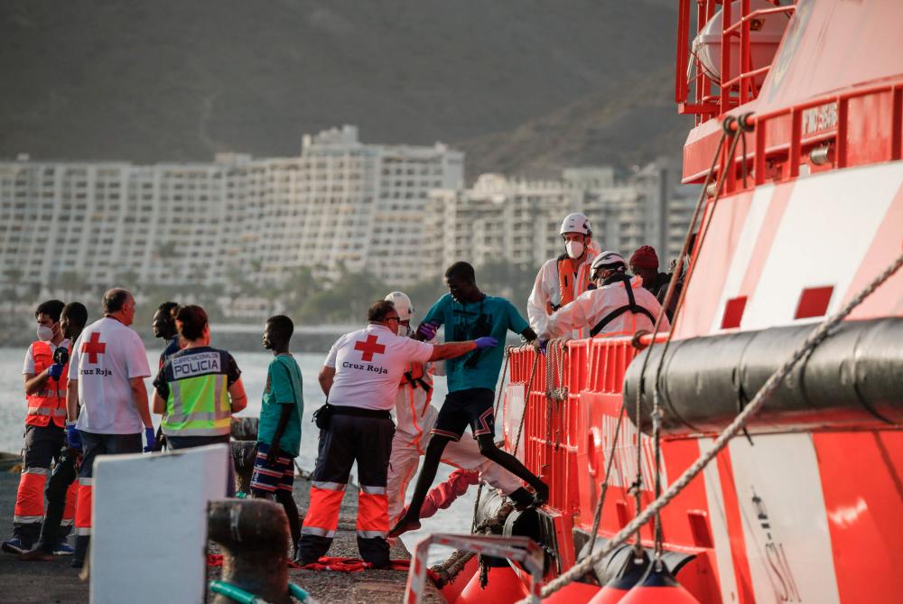 Migrants disembark from a Spanish Maritime Rescue vessel in the Port of Arguineguin on the Canary Island of Gran Canaria, on July 10, 2023. AFPPIX