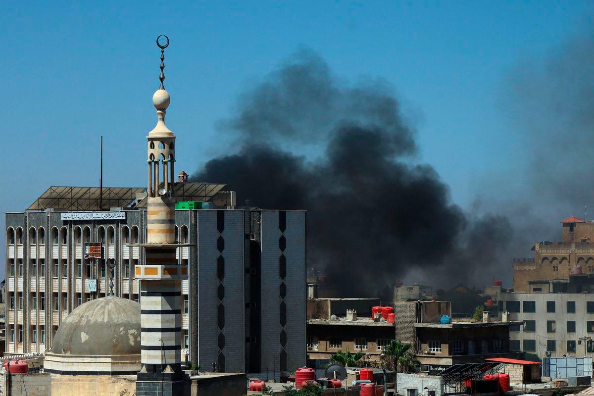Smoke billows during clashes in the predominantly Druze city of Sweida on July 15, 2025. (Photo by Shadi AL-DUBAISI / AFP)