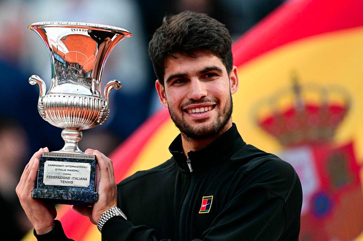 Spain's Carlos Alcaraz shows his winner trophy at the end of his men's singles final match against Italy's Jannik Sinner for the ATP Rome Open tennis tournament at Foro Italico in Rome on May 18, 2025. - AFPPIX