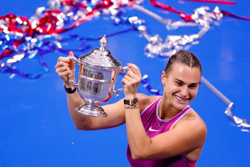 Belarus's Aryna Sabalenka holds up the trophy after defeating USA's Jessica Pegula during their women's final match on day thirteen of the US Open tennis tournament at the USTA Billie Jean King National Tennis Center in New York City, on September 7, 2024. - AFPPIX