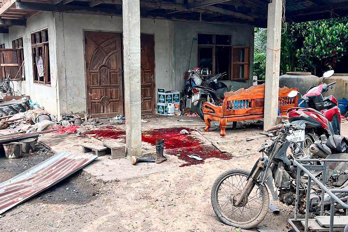 This handout picture taken and released by the Royal Thai Army on July 24, 2025 shows blood stains in front of a damaged house by a rocket strike in Surin province’s Kap Choeng district. - AFP PHOTO / ROYAL THAI ARMY