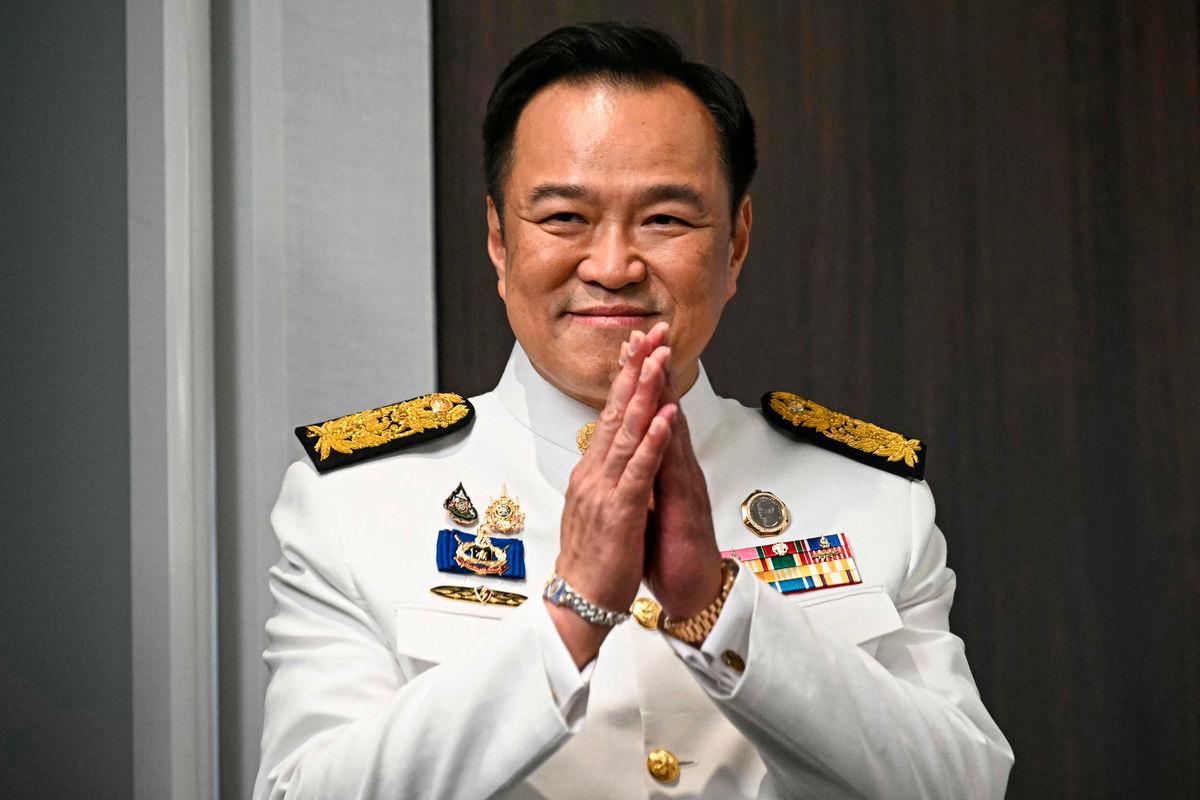 Thailand’s new prime minister Anutin Charnvirakul greets media representatives as he arrives to deliver remarks after the royal endorsement ceremony, at the Bhumjaithai Party’s headquarters in Bangkok on September 7, 2025. (Photo by Lillian SUWANRUMPHA / AFP)