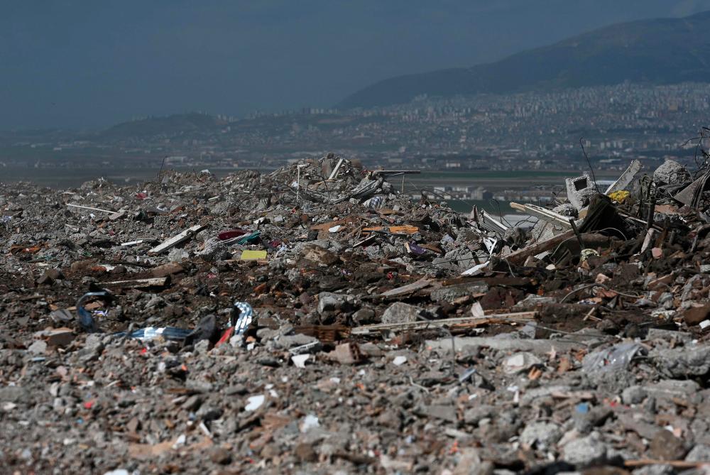A photo shows debris from collapsed buildings dumped on top of a hill in Kahramanmaras, on March 4, 2023, one month after a massive earthquake struck south-east Turkey. AFPPIX