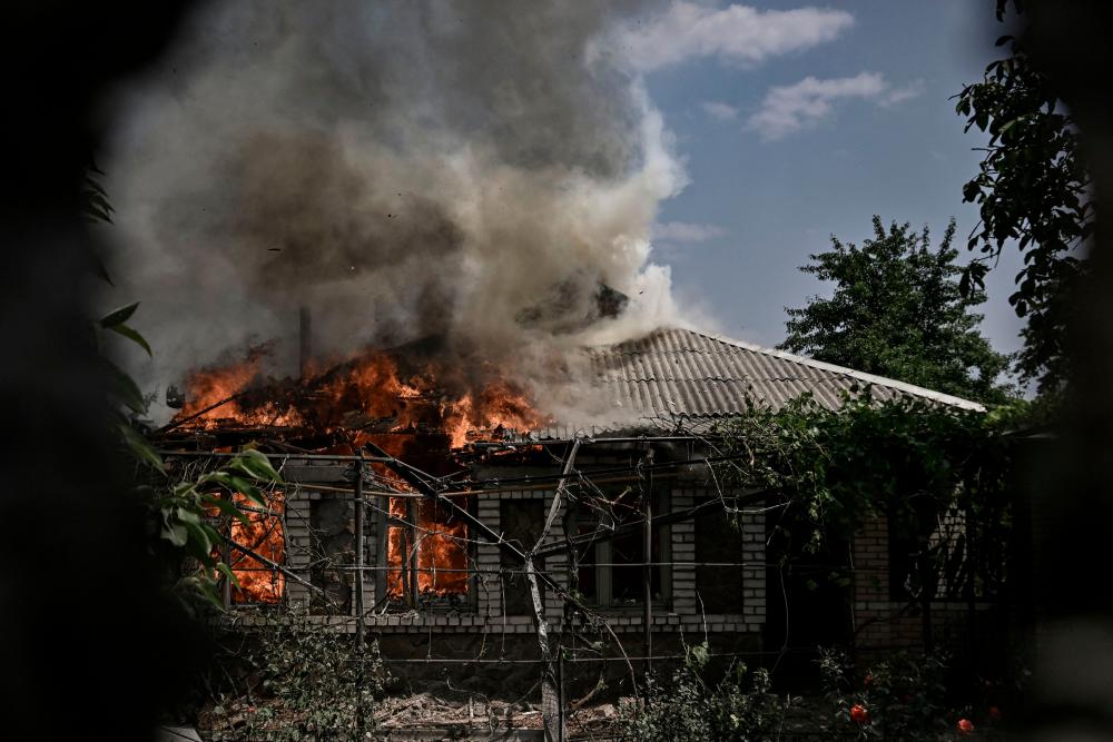 A house burns after being shelled during an artillery duel between Ukrainian and Russian troops in the city of Lysychansk, eastern Ukrainian region of Donbas, on June 11, 2022. AFPPIX