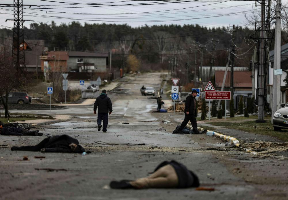 Graphic content - Bodies lie on a street in Bucha, northwest of Kyiv, as Ukraine says Russian forces are making a “rapid retreat” from northern areas around Kyiv and the city of Chernigiv, on April 2, 2022. AFPPIX
