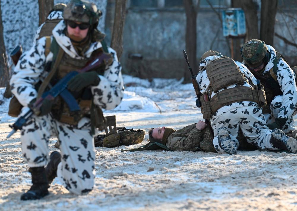 Servicemen take part in a joint tactical and special exercises of the Ukrainian Ministry of Internal Affairs, the Ukrainian National Guard and Ministry Emergency in a ghost city of Pripyat, near Chernobyl Nuclear Power Plant on February 4, 2022. AFPPIX